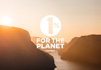 Sunrise over mountains and a river valley, with the text 1% FOR THE PLANET MEMBER in bold white letters centered over the image. The scene is warm and peaceful, emphasizing nature and environmental focus.