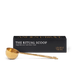 A stainless steel golden Ritual Scoop by Ancient + Brave rests before a black box—an ideal wellness gift to enhance your self-care ritual.