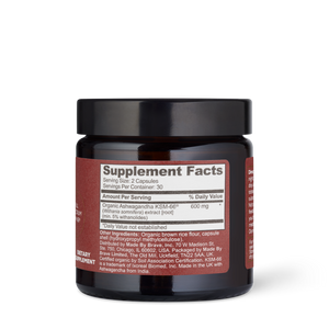 A dark brown True Ashwagandha jar by Ancient + Brave features a red label with the Supplement Facts panel, highlighting Organic Ashwagandha root extract for balance, plus serving size and directions.