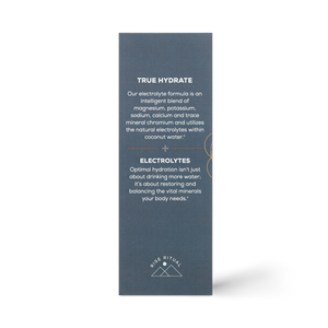 A tall, dark box for Ancient + Brave True Hydrate Sachets features white text on its mineral blend electrolyte formula and hydration benefits. At the bottom are a small mountain logo and the words “RISE RITUAL.”.