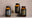Three bottles with decorative labels on a neutral background
