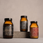 Three brown glass jars with labels on a neutral background. True Collagen, True Creatine and True Nightcap.