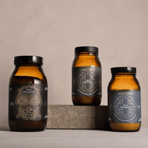 Three amber glass bottles with black lids on a neutral background. True Collagen, True Creatine and True Hydrate.