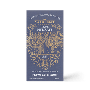 A navy blue box labeled Ancient + Brave True Hydrate features gold geometric designs and text such as Advanced Electrolyte Powder, mineral blend for active lifestyles, Rise Ritual, Intelligent Mineral Formula, Dietary Supplement, and Vegan.