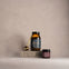 Two jars and a spoon on a gray surface with a beige background. Wild Collagen and Noble Collagen.