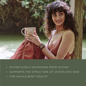 A woman in a flowing, sleeveless dress sits by the water, holding a mug and smiling. Text reads: + Ancient + Brave True Collagen* + Supports joints & skin structure* + Whole body health support*.