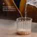A glass cup with powder at the bottom sits on a wooden surface as water is poured in. Text beside the glass reads: True Nightcap by Ancient + Brave—soothing blend of L-glycine, My-inositol, Choline & Vitamin C.