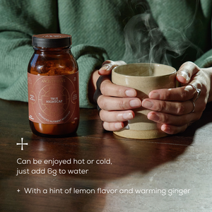 A person holds a steaming mug with both hands beside a brown jar labeled Ancient + Brave True Nightcap. Text: Enjoy hot or cold—just add 6g to water. A soothing blend with lemon, ginger, and nutrients for your Rest Ritual.