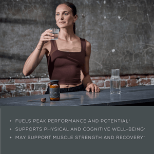 A woman in athletic wear stands by a counter, holding a glass of water. A supplement bottle, gold spoon, and glass carafe are on the counter. Text reads: Fuels peak performance and potential, and other health benefits.