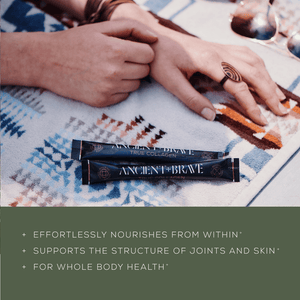 Two hands rest on a patterned blanket next to two sachets labeled Ancient + Brave True Collagen. Text below highlights the product’s benefits: nourishing from within, supporting joints and skin, and whole body health.