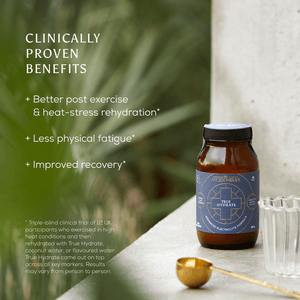 A brown glass bottle labeled Dawn to Dusk Duo by Ancient + Brave US sits on a stone surface near a clear glass and gold spoon. Text beside it highlights clinically proven benefits like deep hydration, less fatigue, and improved recovery.