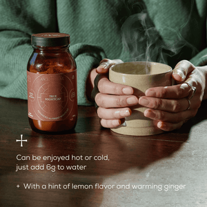 A person holds a steaming mug with both hands next to a jar labeled True Nightcap. Text reads: Can be enjoyed hot or cold, just add 6g to water. With a hint of lemon flavor and warming ginger.