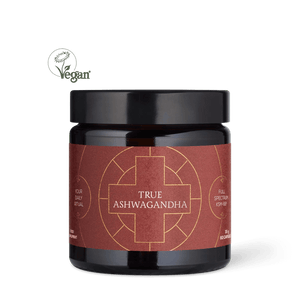 Jar of True Ashwagandha with a black lid on a dark background